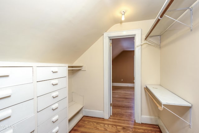 spacious closet featuring wood-type flooring and vaulted ceiling
