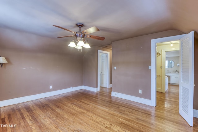 empty room with ceiling fan, sink, and light wood-type flooring