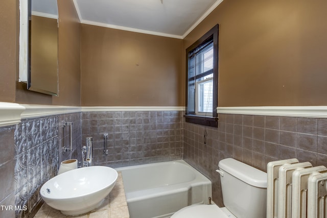 bathroom with a bathing tub, radiator, crown molding, and toilet