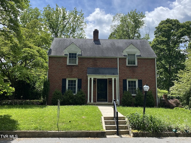 346 N St, Marion, VA 24354 - view of front of property featuring a chimney, a front lawn, and brick siding