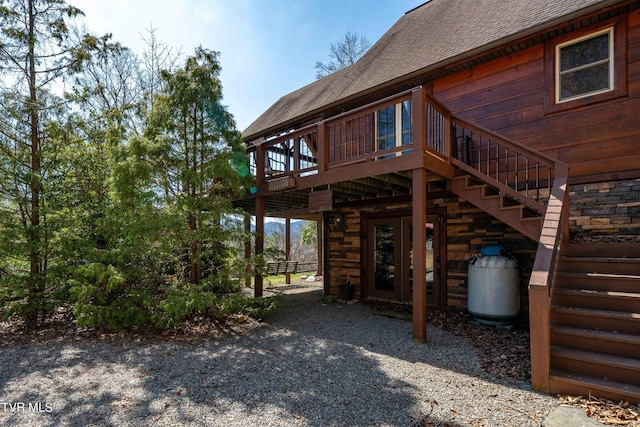 view of side of home featuring a wooden deck