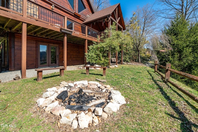 view of yard with french doors, a deck, and a fire pit