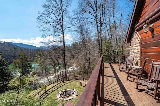 wooden deck featuring a water and mountain view