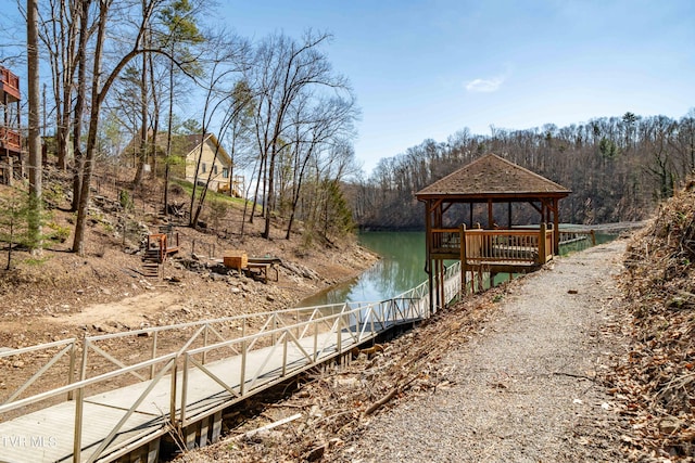 view of dock with a gazebo and a water view