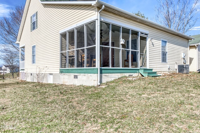 view of side of property with central AC, a sunroom, and a lawn