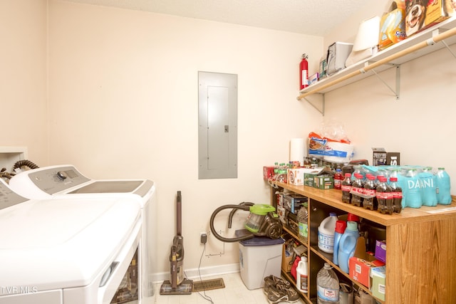 laundry area featuring separate washer and dryer, electric panel, and a textured ceiling