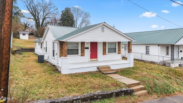 bungalow-style house with cooling unit, a front lawn, and a porch
