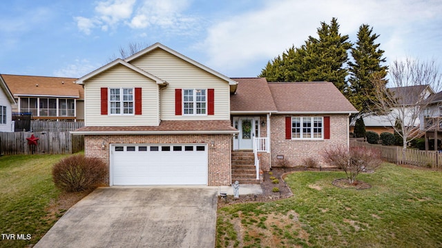 tri-level home featuring a garage and a front yard