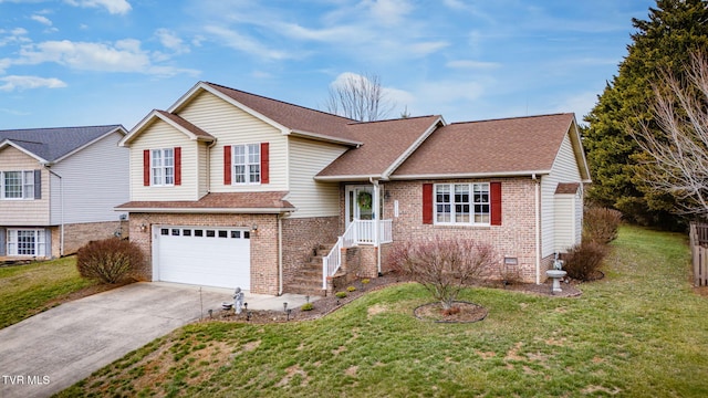 tri-level home featuring a garage and a front yard