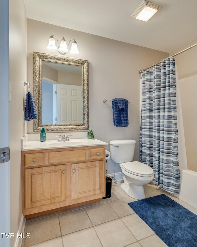 full bathroom with shower / tub combo with curtain, vanity, tile patterned flooring, and toilet