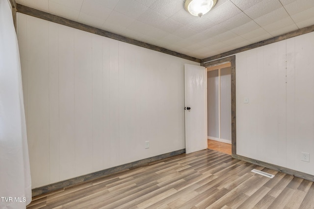 unfurnished room featuring wood-type flooring