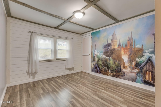 unfurnished room with hardwood / wood-style flooring, coffered ceiling, and wood walls