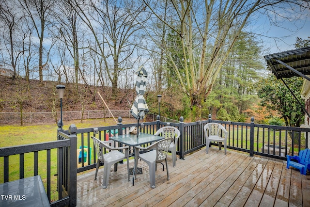 wooden deck with a lawn