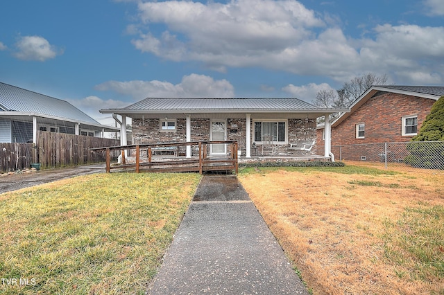 view of front of house with covered porch and a front lawn