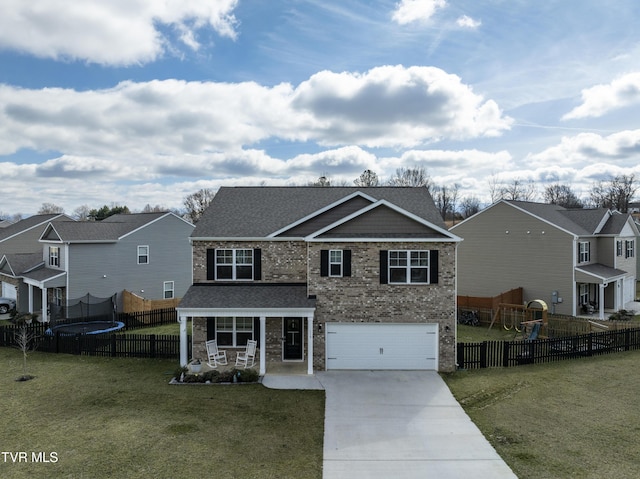 view of front facade with a trampoline, a front lawn, a porch, and a garage