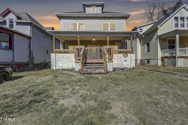 view of front of home featuring a lawn and covered porch