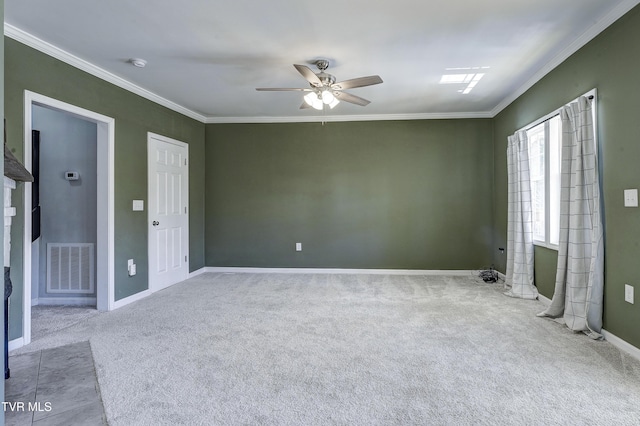 carpeted spare room with crown molding and ceiling fan