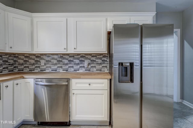 kitchen featuring white cabinets, appliances with stainless steel finishes, and wooden counters