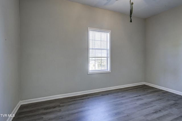 spare room with dark hardwood / wood-style flooring