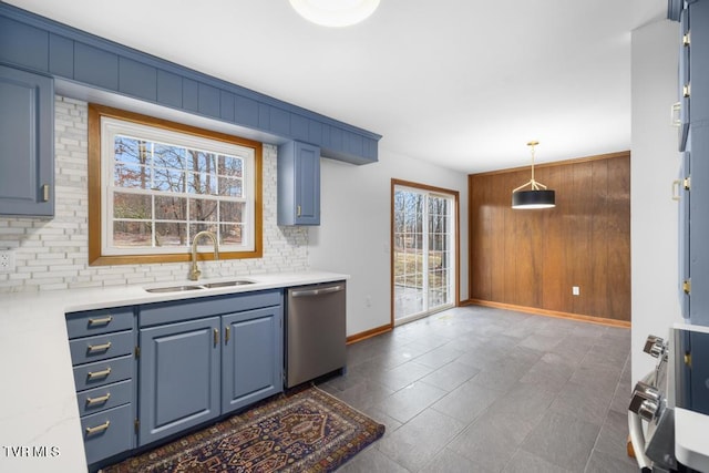 kitchen featuring pendant lighting, sink, stainless steel dishwasher, and blue cabinetry