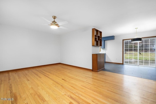 unfurnished living room featuring ceiling fan and light wood-type flooring