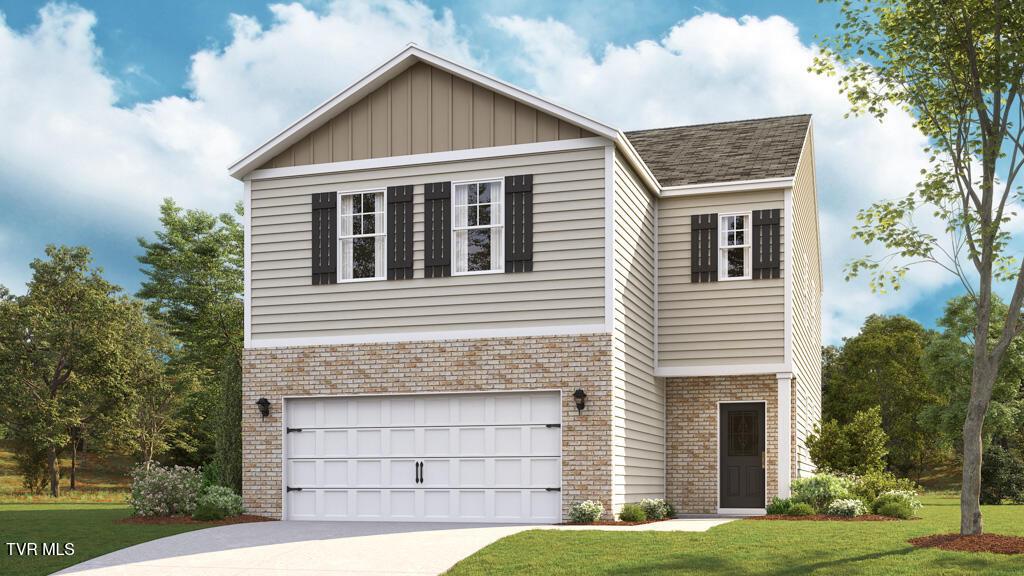 view of front of home with a garage and a front lawn