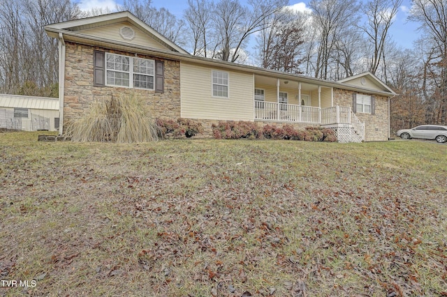 single story home featuring covered porch and a front yard