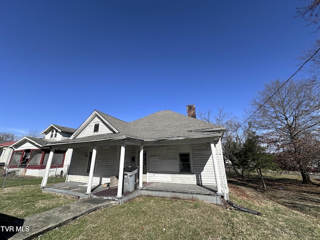 bungalow-style home with a porch and a front lawn