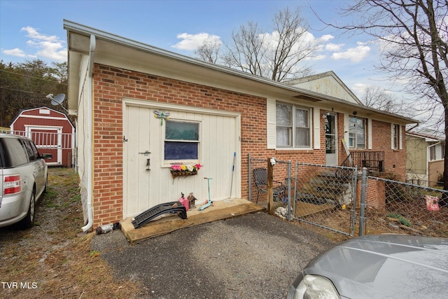 ranch-style home with a storage unit