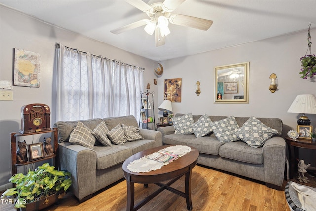 living room featuring hardwood / wood-style floors and ceiling fan