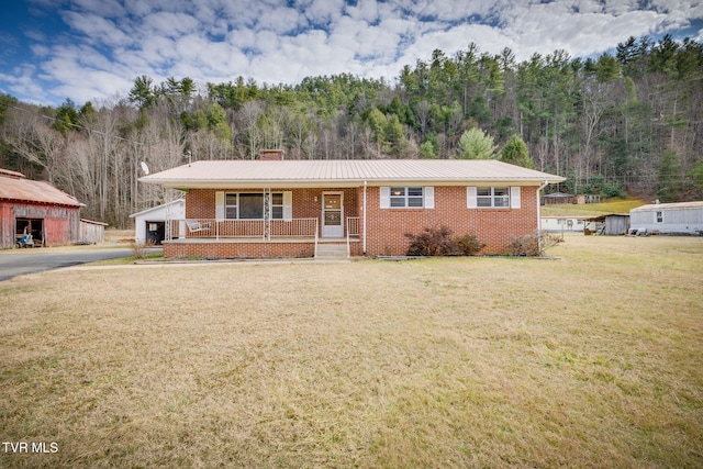 view of front of home with a front yard and covered porch