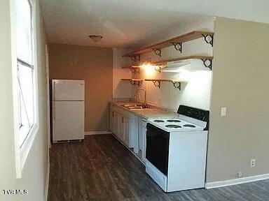 kitchen featuring white appliances, sink, and dark hardwood / wood-style flooring