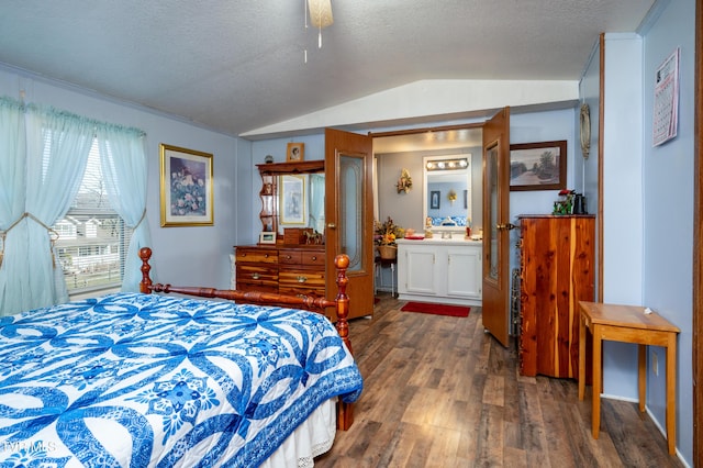 bedroom with lofted ceiling, connected bathroom, dark hardwood / wood-style flooring, and a textured ceiling