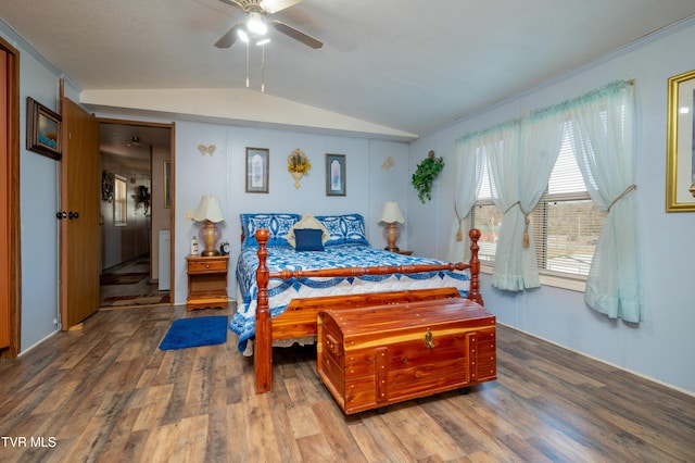 bedroom with hardwood / wood-style flooring, ceiling fan, and vaulted ceiling