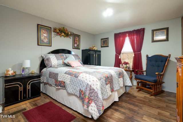 bedroom with dark wood-type flooring