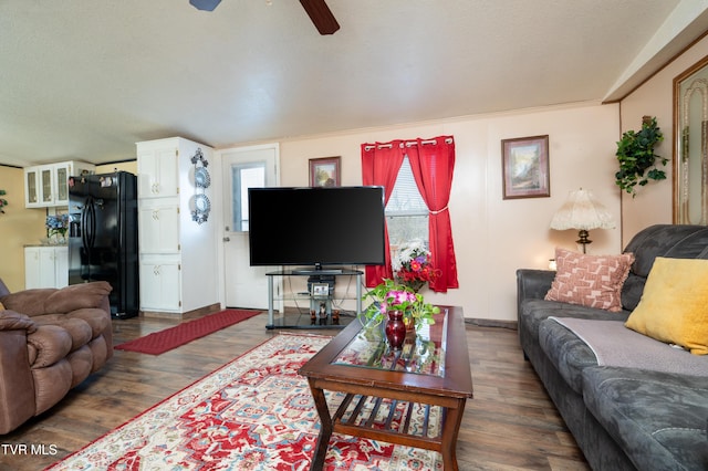 living room with dark wood-type flooring and ceiling fan