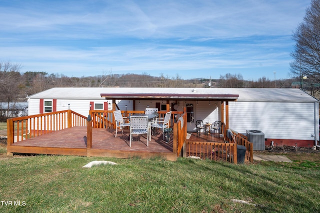 wooden terrace with cooling unit and a yard