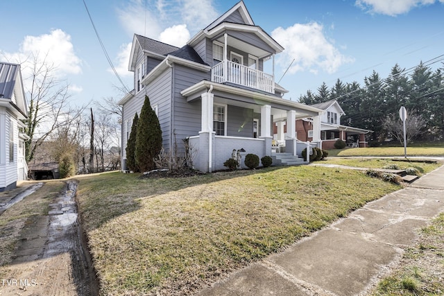 view of front of home featuring a porch, a balcony, and a front lawn