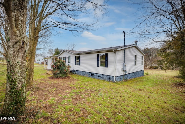 view of property exterior with covered porch and a lawn