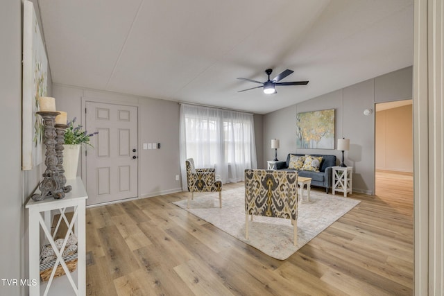 living room with lofted ceiling, light hardwood / wood-style floors, and ceiling fan