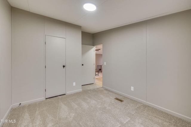 unfurnished bedroom featuring light carpet