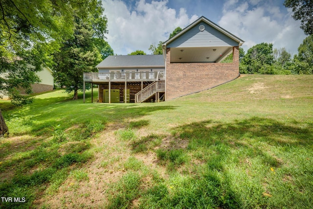 rear view of property featuring a wooden deck and a lawn