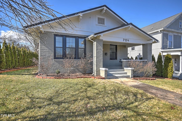 view of front of house with a porch and a front lawn