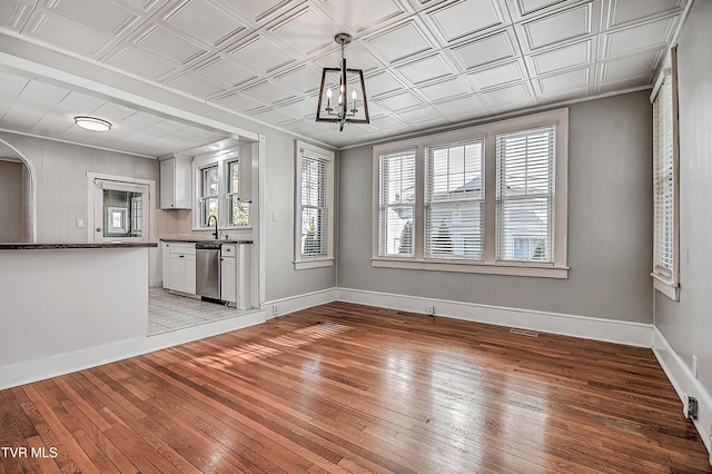 interior space with an inviting chandelier, sink, and light wood-type flooring