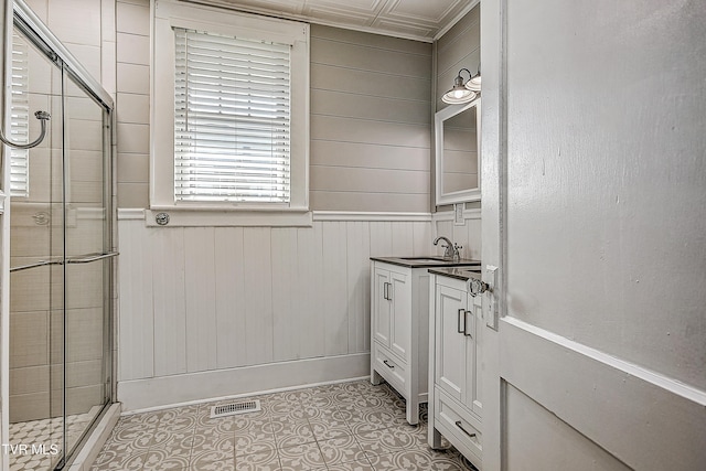 bathroom with tile patterned flooring, vanity, and a shower with door