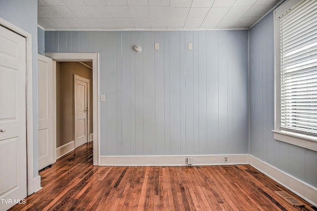 unfurnished room featuring dark wood-type flooring