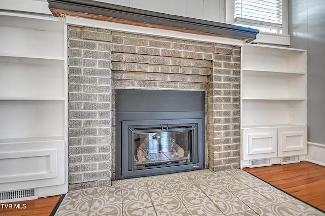 details with hardwood / wood-style flooring and a fireplace