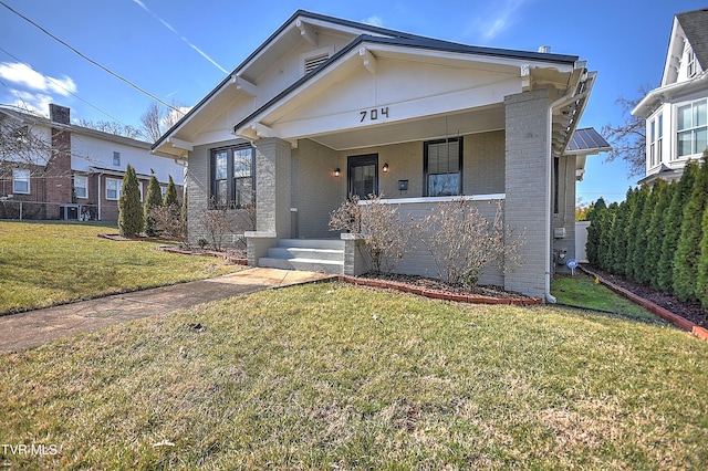 view of front of home with a porch and a front lawn