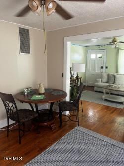 dining room with hardwood / wood-style flooring and ceiling fan