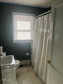 bathroom with tile patterned floors, toilet, a shower with shower curtain, and vanity